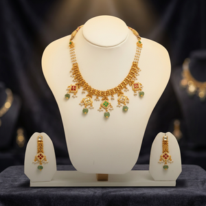 Traditional gold temple <b>necklace</b> <b>set</b> with pearl strands green bead drops red stone motifs <b>and</b> matching elegant <b>earrings</b> - Product Image 1