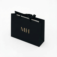 Sac en papier cadeau noir de luxe avec logo personnalisé imprimé pour chaussures, vêtements, shopping, mariage, emballage de bijoux avec poignées en ruban