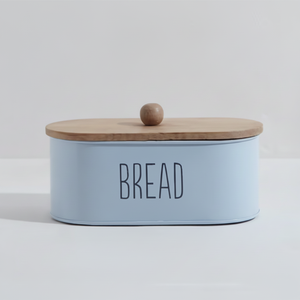 Panera ovalada de metal azul pastel con tapa y pomo de madera, letras negras de 'BREAD', disponible a precios de mayoreo - Product Image 1