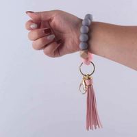 Porte-clés en perles de silicone avec bracelet porte-clés extensible en silicone Porte-clés porte-clés en cuir avec pendentif et pompon