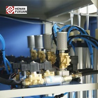 Nouvelle souffleuse de bouteilles PET semi-automatique Fuxuan à 4 cavités avec contrôle PLC et composants essentiels pompe/moteur 220V