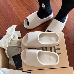 bone yeezy slides on feet