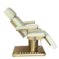 Table de massage électrique chauffante avec base dorée, éclairage LED et commande au pied pour spa, salon de beauté et institut.