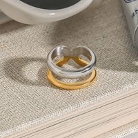 Mode féminine MW Bague étanche en acier inoxydable plaqué or 18 carats bicolore à double couche en forme de X avec lignes simples et élégantes