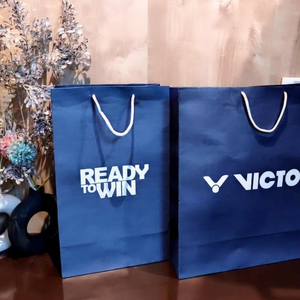 Luxury Blue <b>Paper</b> Carry Bags with White Rope Handles for Clothing Stores Boutiques Events and Promotional Packaging - Product Image 1