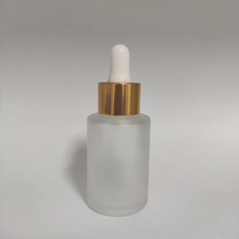 frosted bottle with gold dropper head