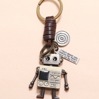 Porte-clés robot dessin animé rétro unique et simple, en cuir véritable, avec bras et jambes mobiles, fabriqué en Chine, accessoire créatif pour sac