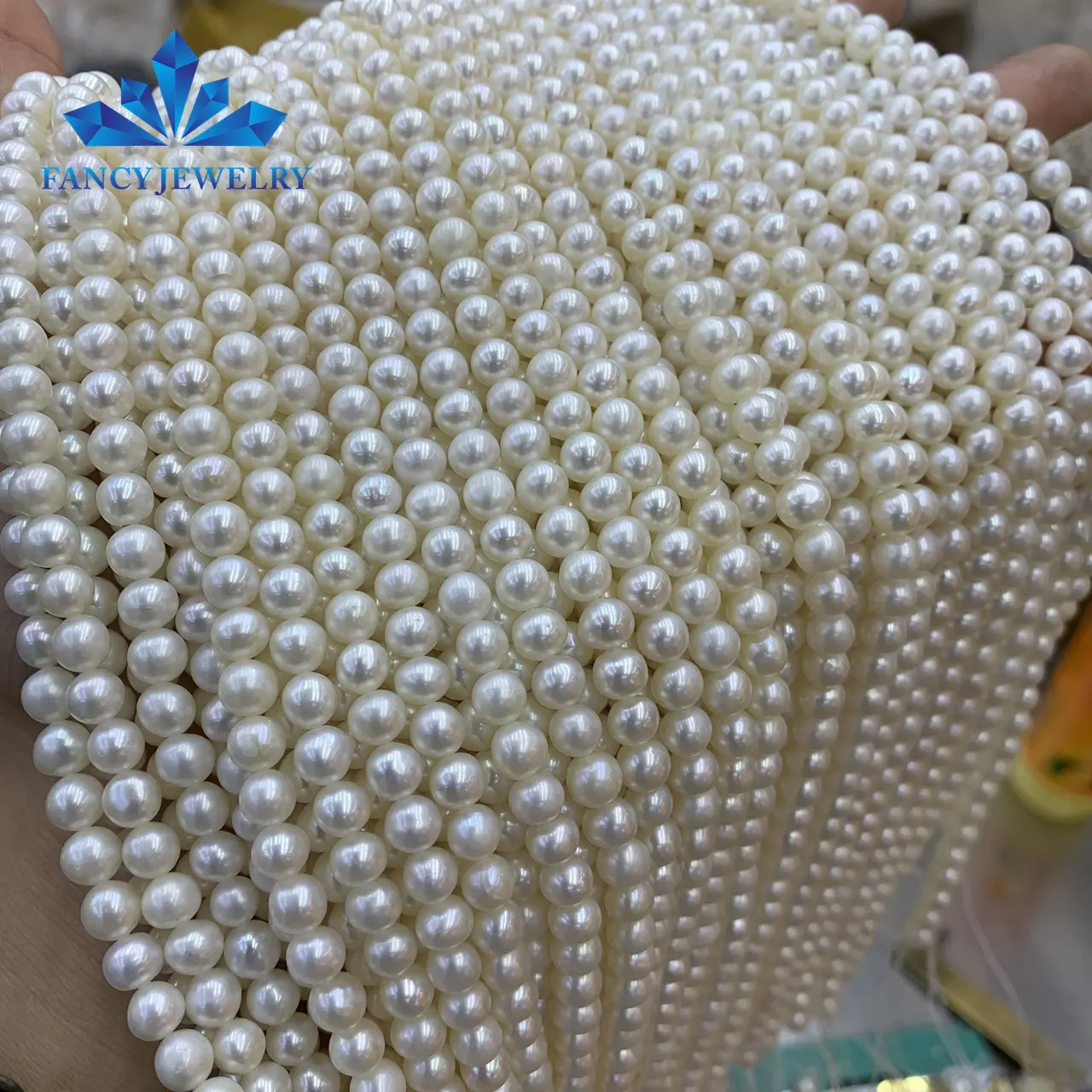 Wholesale AAA grade Near round shape slight blemish 5-6mm white natural freshwater pearl loose long pearl string price
