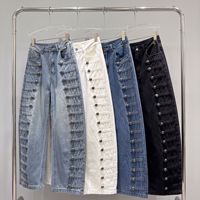 Le nouveau style d'automne américain : jeans à boutons côtelés en métal vieilli, coupe ample et courbée, pantalons à jambes larges et pantalons longs.