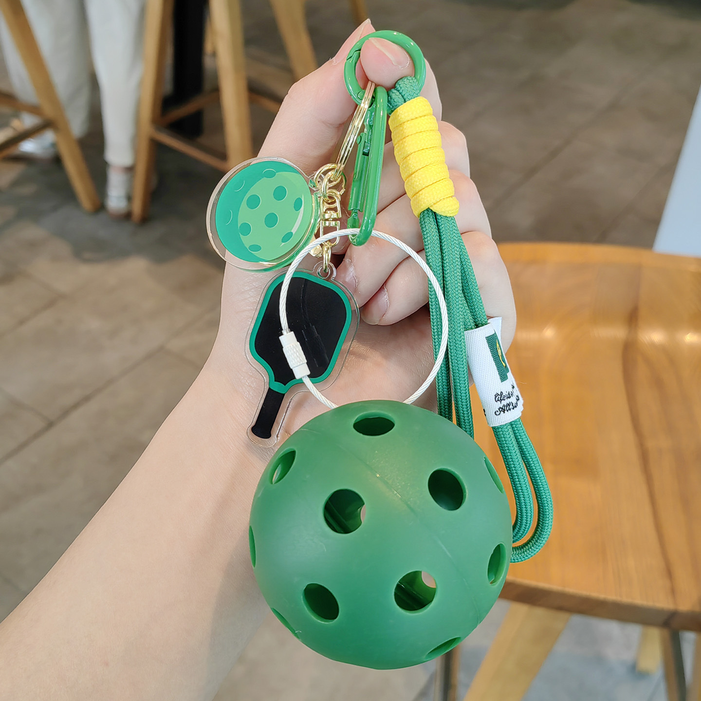 Green racket, green string, dark green ball