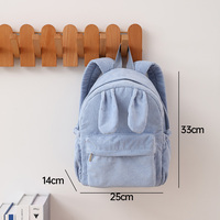 Sac à dos en velours côtelé personnalisé en gros avec oreilles de lapin, poche avant zippée, poches latérales à cordon de serrage, bretelles réglables
