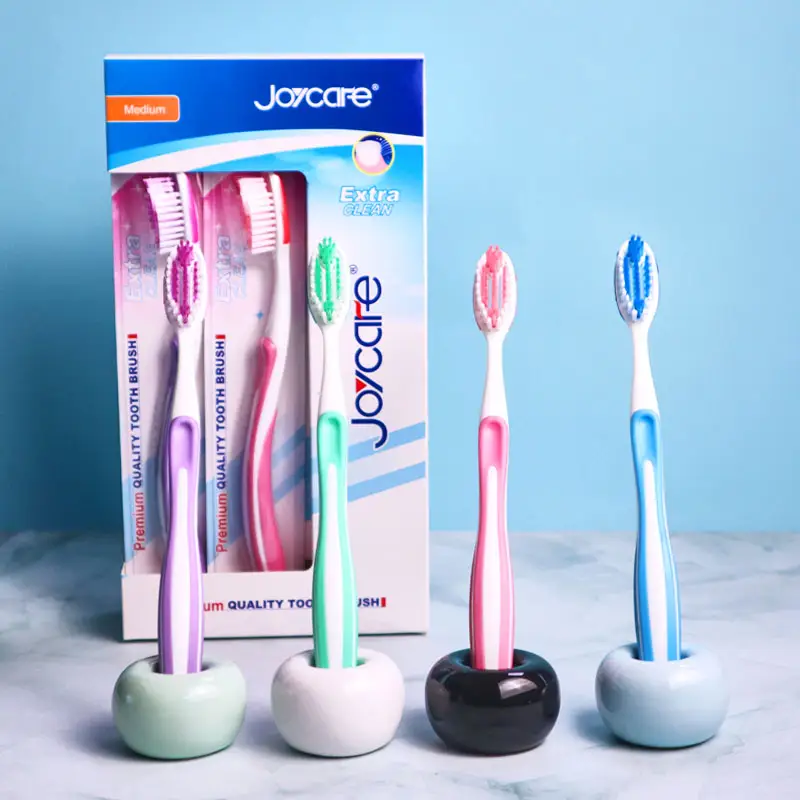 Campione gratuito all'ingrosso spazzolino da denti in plastica per adulti con denti puliti di buona qualità