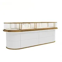 Comptoir de présentation de bijoux en verre LED doré champagne à panneaux rainurés verticaux, base en bois clair, vitrine de boutique