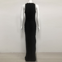 Robe longue élégante noire pour femme avec bordure perlée, motif visage en strass, fente haute et bandage, idéale pour les soirées