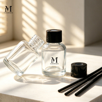 Bouteille diffuseur en verre transparent rond avec bouchon à vis et bâtonnets parfumés