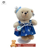 Teddy ISLAND - Poupée ours en peluche avec robe florale bleu clair et accessoire nœud bleu, sous licence mondiale