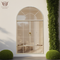 Ventanas abatibles estilo granja francesa DEMEA con marco de aluminio negro y rejas de seguridad para villa rural