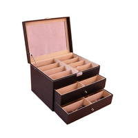 Caja expositora de gafas de cuero PU naranja, negro y verde con 24 ranuras y 2 cajones, nueva, al por mayor