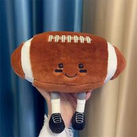 Peluche de football mignonne avec jambes, coussin en peluche doux en forme de ballon de rugby, cadeau en peluche sportif de dessin animé