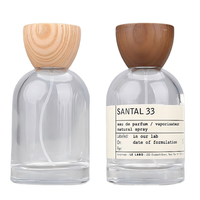 Flacon pulvérisateur de parfum rond en verre transparent rechargeable avec bouchon en bois 30ml/50ml/100ml pour emballage cosmétique et parfum, OEM/ODM disponible