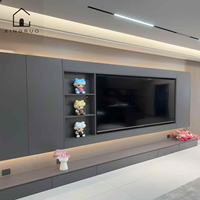 Meuble TV mural moderne noir personnalisé XINGRUO avec éclairage LED, rangement intégré, console multimédia et étagères de présentation