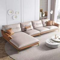Ensemble de canapés d'angle en cuir véritable confortable et personnalisé de style européen, avec des pieds en métal doré élancés