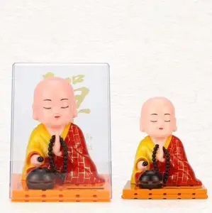 Solar energy Buddhist monk knocks on wooden fish car interior decoration