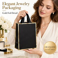 Sacs cadeaux en papier spécial noir et or avec poignées en ruban pour emballages de luxe de bijouteries et boutiques de détail