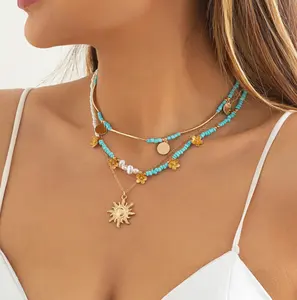 Collier de perles vintage en perles de riz avec pendentif tournesol bleu