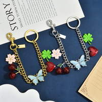 Pendentif de sac en alliage de zinc, motif cerise, papillon, trèfle, cœur, bicolore or et argent, ornement de sac fleur, porte-clés tendance