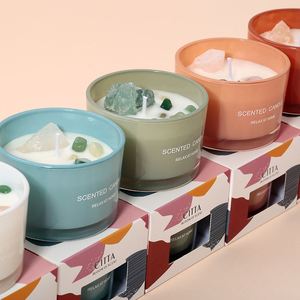 Mini gemstone-scented natural candle in amber glass with visible amethyst chips
