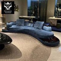 Canapé d'angle incurvé en cuir de luxe pour salon familial, canapé de salon bleu incurvé avec table basse