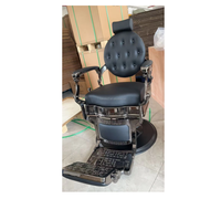 Chaise de barbier à cadre noir pistolet rond de luxe rétro adaptée aux salons haut de gamme