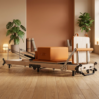 Reformer de Pilates pliable en bois d'érable nord-américain importé avec pieds en fer, lit de Pilates pour usage domestique avec couleur de cuir personnalisée