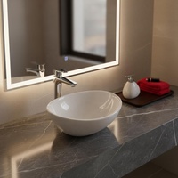 Vasque en céramique ovale de petite taille à surface lisse moderne pour salle de bain et hôtel, vente en gros