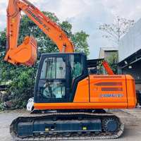Excavatrice hydraulique CDM6135N 74 kW pour travaux de terrassement avec godet de 0,56 m³, marteau brise-roche et système de conduites pour terrassement