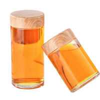 Pot à miel rond en verre transparent de qualité supérieure avec impression de logo personnalisé et emballage élégant en boîte cadeau pour les marques gastronomiques
