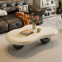 Table Basse Nuage Nordique Minimaliste et Luxueuse Crème Blanc Unique et Élégante avec Piétement Sphérique Noir
