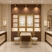 Vitrine à bijoux en marbre blanc sculpté doré, vitrine européenne en aluminium avec verre incurvé et éclairage LED, taille personnalisée pour boutique de détail