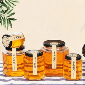 Grand pot de stockage en verre hexagonal 13oz 16oz 24oz pour le miel avec couvercle supérieur à vis