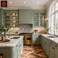 Meubles de cuisine personnalisables vert sauge, style classique français, en bois massif, avec grand îlot central et armoire de rangement en bois.