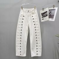 Le nouveau style d'automne américain : jeans à boutons côtelés en métal vieilli, coupe ample et courbée, pantalons à jambes larges et pantalons longs.
