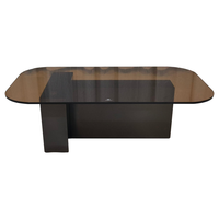 Table basse ovale avec plateau en verre fumé et base en acier inoxydable noir