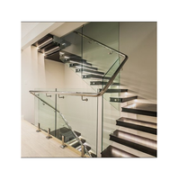 Escaliers flottants modernes en forme de L avec garde-corps en verre et main courante latérale