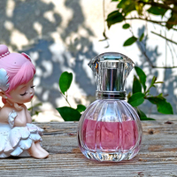 Flacon de parfum en verre transparent de 50 ml, forme cylindrique, col fileté de 15 mm, gravure personnalisée, design unique, avec emballage boîte.