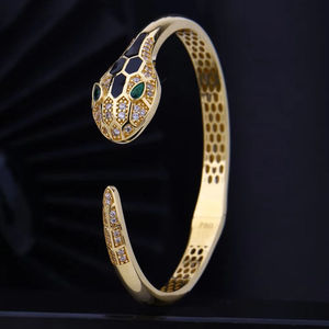 Elegant Gold <b>Bangle</b> <b>Bracelet</b> for Women Diamond Studded with Enamel Accents and Emerald Green Eye Detailing - Product Image 1