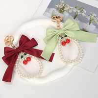 Porte-clés créatif polyvalent avec nœud papillon et petites perles, pendentif pour sac de téléphone portable pour femme