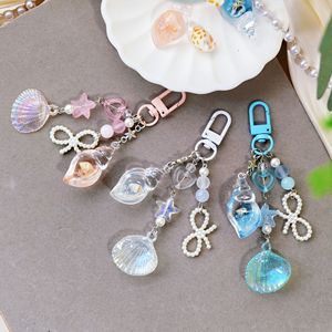 Ciondolo Portachiavi a Forma di Conchiglia della Serie Oceanica, con Perla Simulata, da Appendere al Portafoglio o Zaino, Regali Kerring - Product Image 1