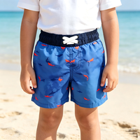 Short de bain Magic Water Reveal Boys Board Short bleu uni avec broderie requin et cordon de serrage blanc réglable pour les vacances d'été à la mer