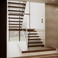Escalier flottant pour résidence moderne avec marches en noyer massif et supports en acier dissimulés